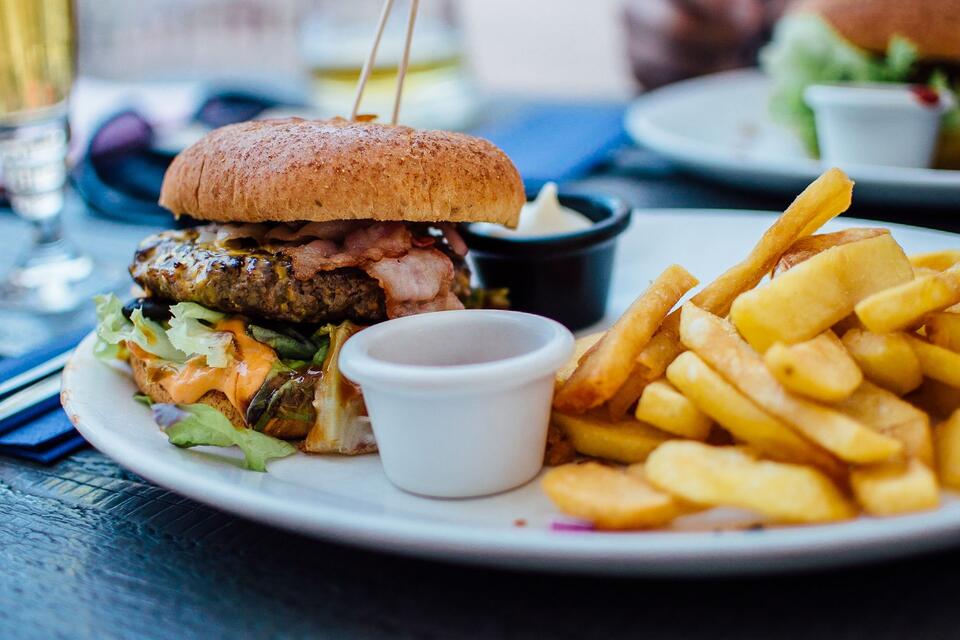 A burger and fries served on a plate, illustrative photograph.