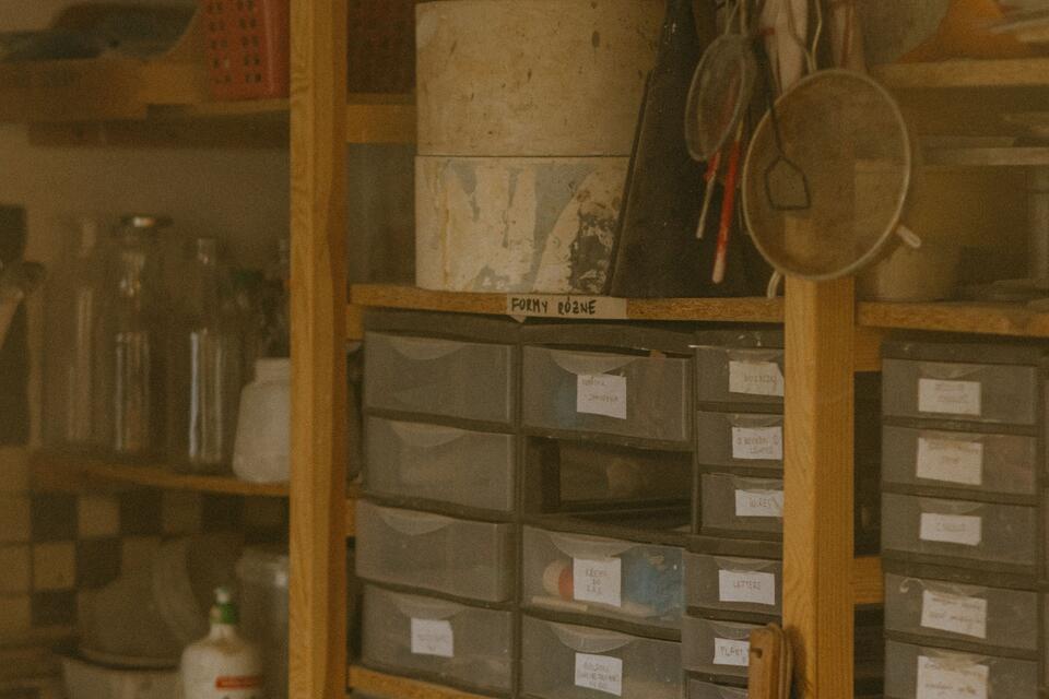 Labelled drawers in wooden shelving, illustrative photo.